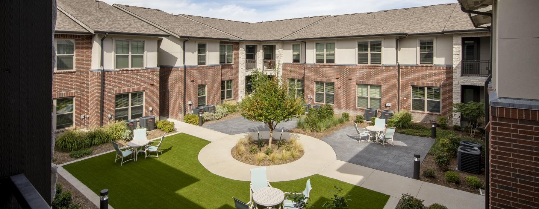 a building with a lawn and chairs