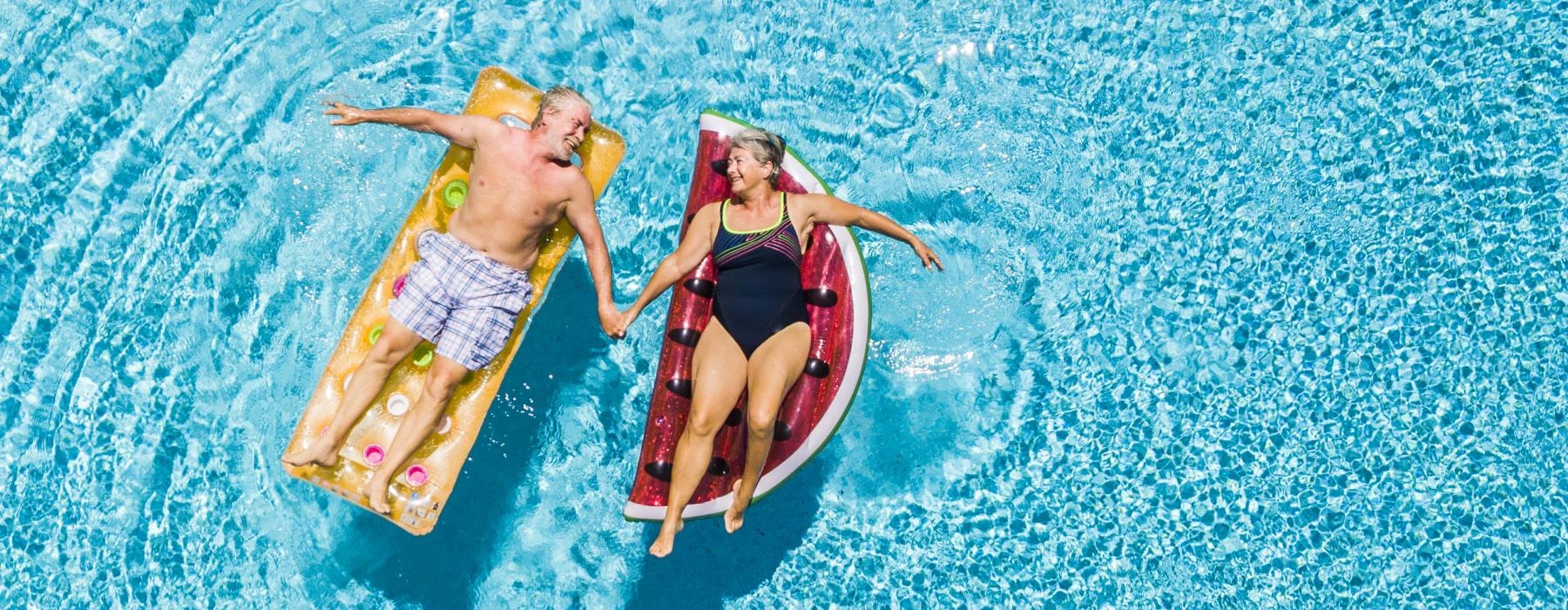 a couple of people in swimsuits in the water